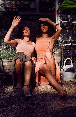 Buy stock photo Hands, sunlight and shade with black woman friends blocking the sun while sitting together at a plant nursery. Spring, gardening and growth with a female and friend outdoor at a flower shop