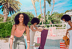 Beach friends, tropical and African women bonding on outdoor summer vacation for peace, freedom and friendship reunion. Trees, nature travel and USA black woman on holiday adventure in Miami Florida