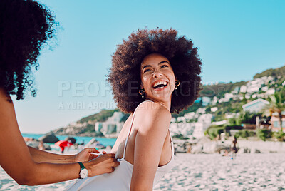 Buy stock photo Sunscreen, black woman and friends at a beach for a happy vacation or holiday to relax with freedom in Miami. Smile, travel and women helping a young gen z girl with skincare cream on back at sea