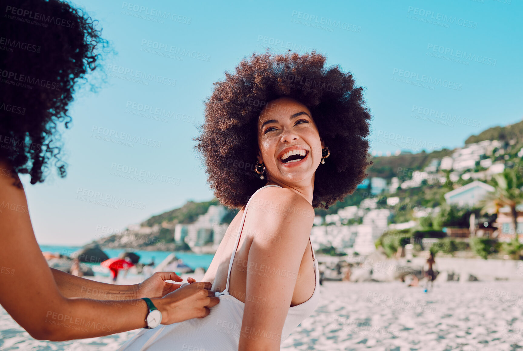 Buy stock photo Sunscreen, black woman and friends at a beach for a happy vacation or holiday to relax with freedom in Miami. Smile, travel and women helping a young gen z girl with skincare cream on back at sea