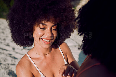 Buy stock photo Sunscreen, skincare and black woman at a beach with friends applying beauty cosmetics on back in Hawaii. Women, relax or happy African girl helping a person with spf protection cream or lotion at sea