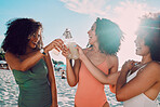 Summer, women and friends beach toast with happy smile for cheers, holiday and fun together. Travel, black people and drink celebration for friendship vacation getaway in Los Angeles, USA.

