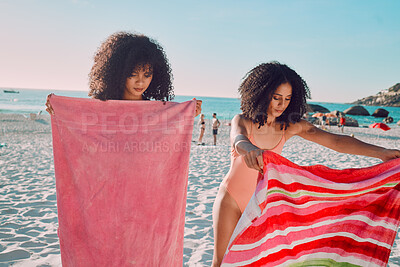 Buy stock photo Woman, friends and beach towel for relaxing on the sand during summer break or vacation together in the outdoors. African American female women opening towels to relax on the sandy ocean coast