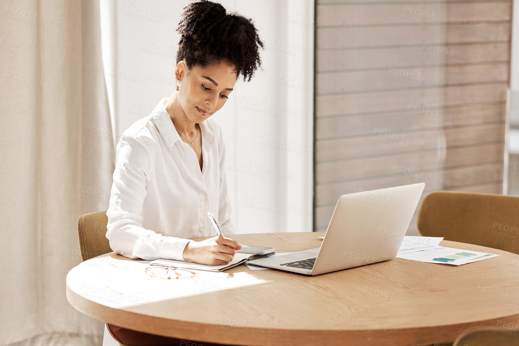 Buy stock photo Woman writing in notebook, laptop on table and home office of accountant, auditor or financial advisor. Finance report, strategy and budget planning, black woman doing research on tax audit documents