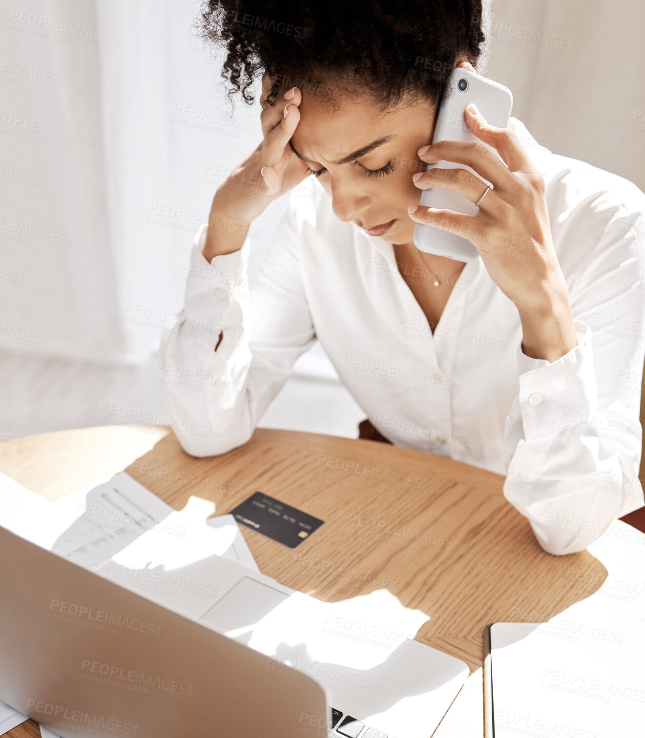 Buy stock photo Black woman, phone call and credit card for debt, frustrated with bills and at desk with laptop. African American female, upset lady or cellphone for connection, communication or payment query stress