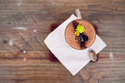 Buy stock photo Coffee shop, barista and hot chocolate art flowers decoration for relaxing and sweet drink break. Cafe, artisan and mocha foam with cocoa powder sprinkle in glass on wood table top view.

