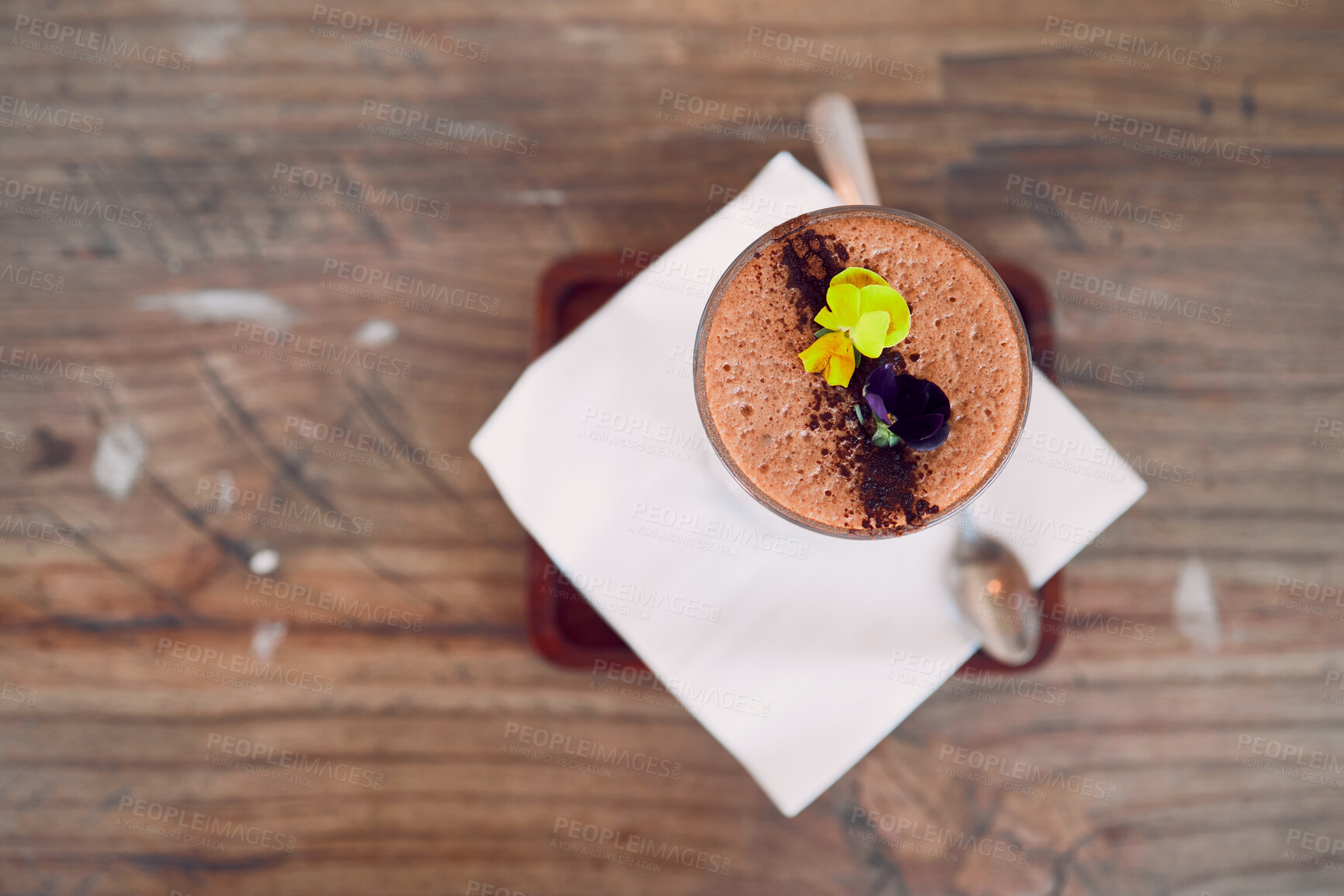 Buy stock photo Coffee shop, barista and hot chocolate art flowers decoration for relaxing and sweet drink break. Cafe, artisan and mocha foam with cocoa powder sprinkle in glass on wood table top view.

