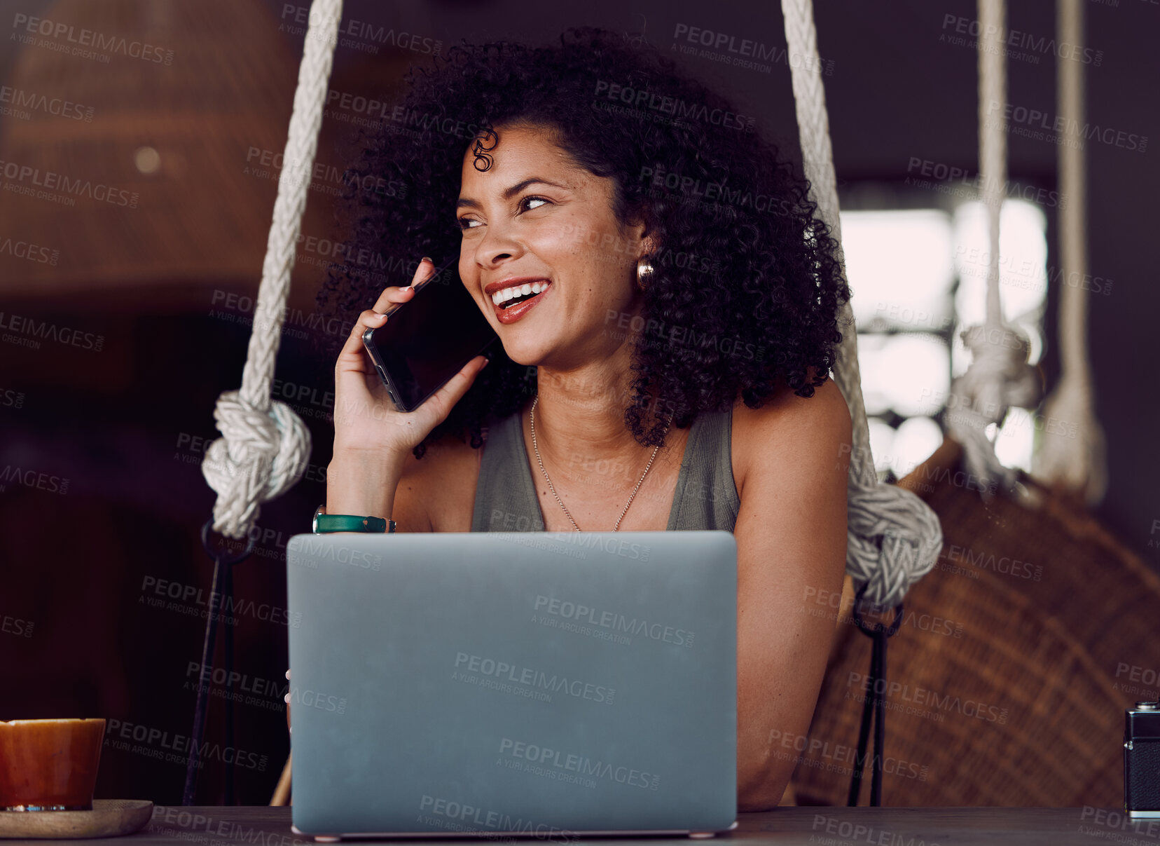 Buy stock photo Black woman, phone call and laughing by laptop in communication, conversation or business discussion at cafe. Happy African American female freelance designer smiling for social networking technology