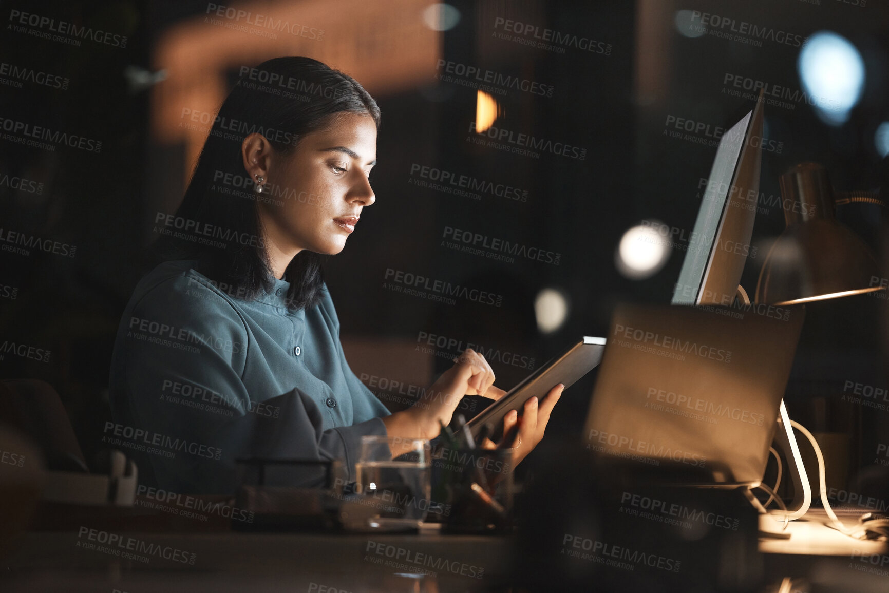 Buy stock photo Woman, office and table on internet at night for overtime, working or digital marketing with technology. Professional businesswoman, late and tech for web, email or communication on app in workplace