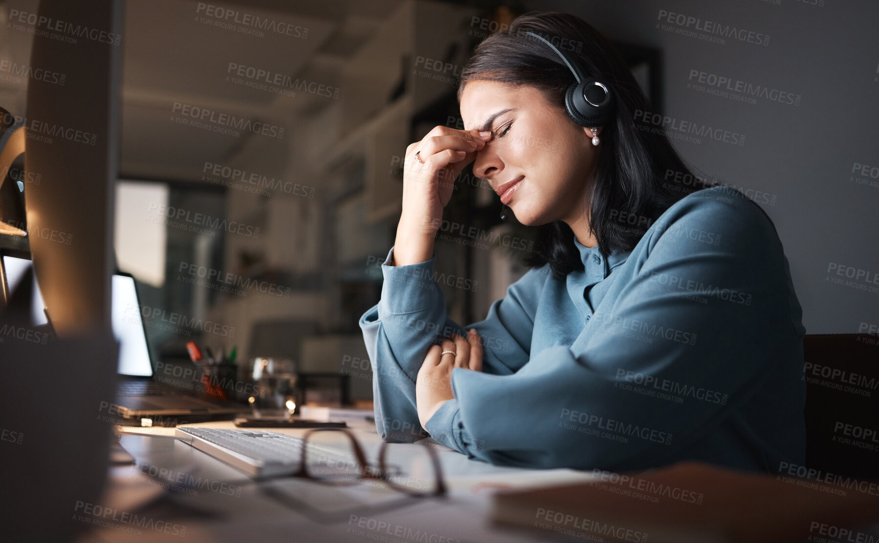 Buy stock photo Stress, burnout and overtime, woman in call center with headache at crm office desk. Tired, frustrated and annoyed customer service consultant at computer working late at night with error or glitch.