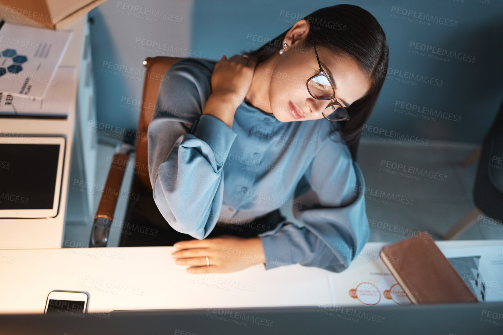 Buy stock photo Woman, neck pain and night in office, working overtime and massage muscle, joint or body ache at desk. Businesswoman, burnout and tired with work injury while sitting at workplace table with stress