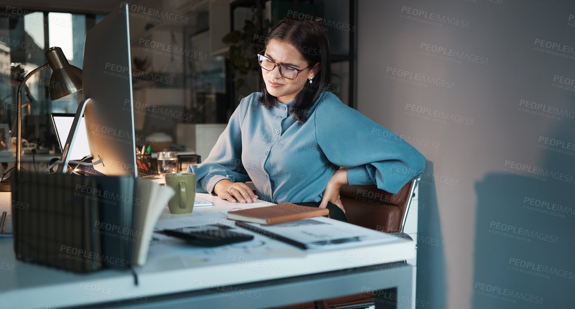 Buy stock photo Business woman, computer or back pain in night office, digital marketing startup or advertising agency company. Tired, stress injury or worker on web design technology and sciatica crisis or burnout