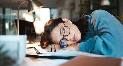 Buy stock photo Tired, burnout and sleep with a business woman sleeping on desk while working on a computer at a desk in his office. Mental health, problem or exhausted with a young female employee at work at night
