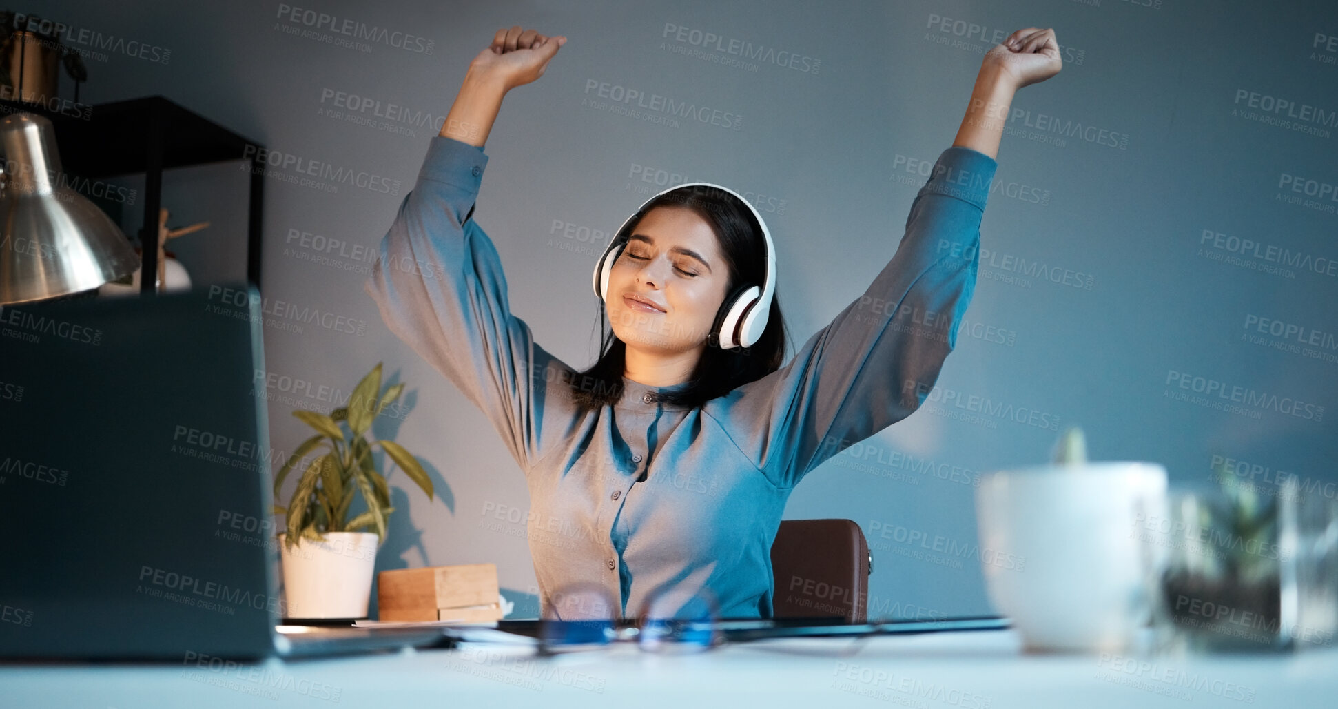 Buy stock photo Woman, night and dance with headphones for music, stress relief or relax singing along alone at home. Female freelancer relaxing, listening or enjoying audio sound track and dancing by workspace desk