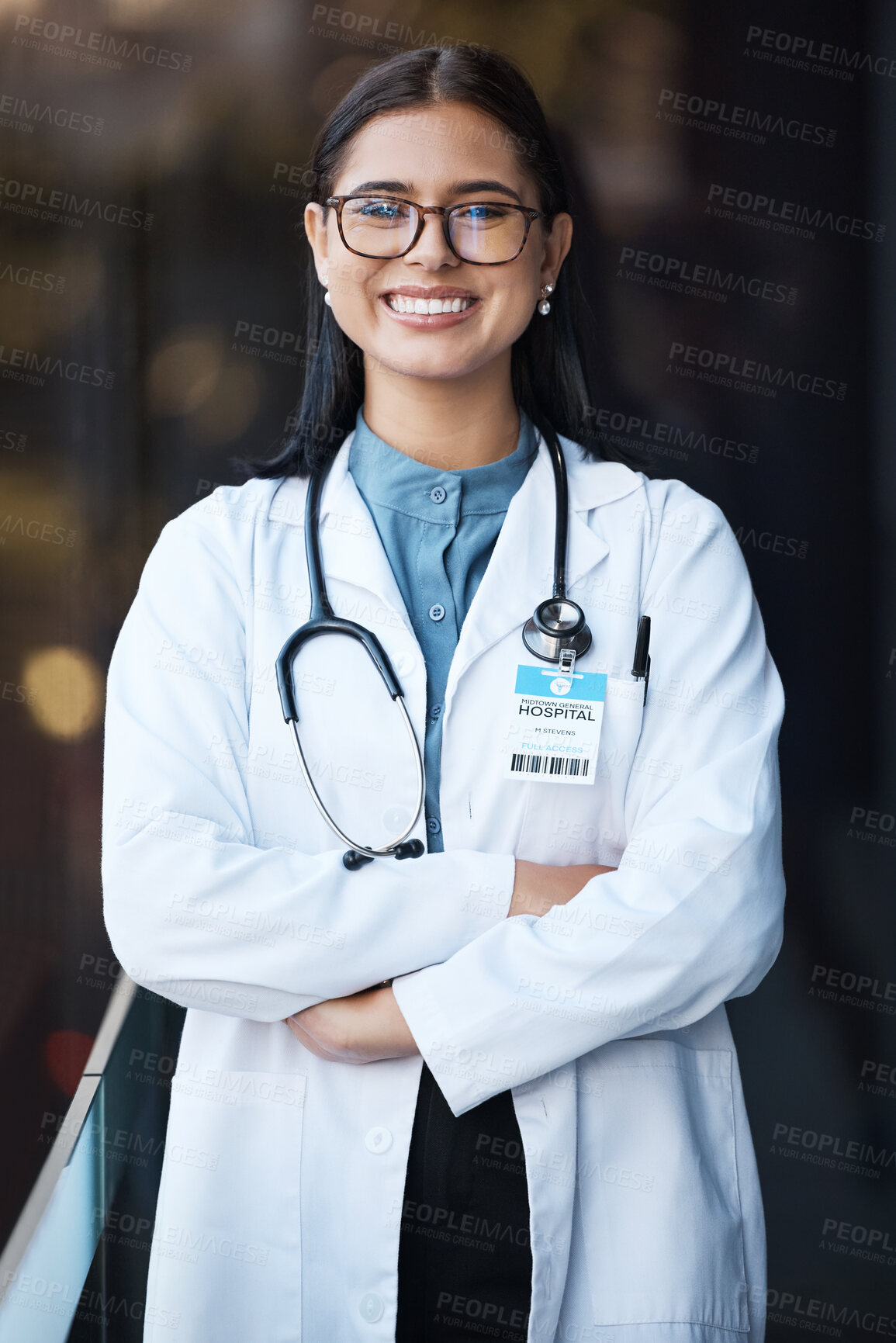 Buy stock photo Healthcare, doctor and portrait of woman with smile and glasses in hospital lobby on happy mission to help. Proud female leader in medical field with vision, trust and leadership at clinic in India.