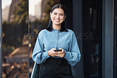 Buy stock photo Phone, portrait and happy with a business woman typing a text message while standing outdoor on an office balcony. Social media, smile and communication with a  female employee sending a mobile email