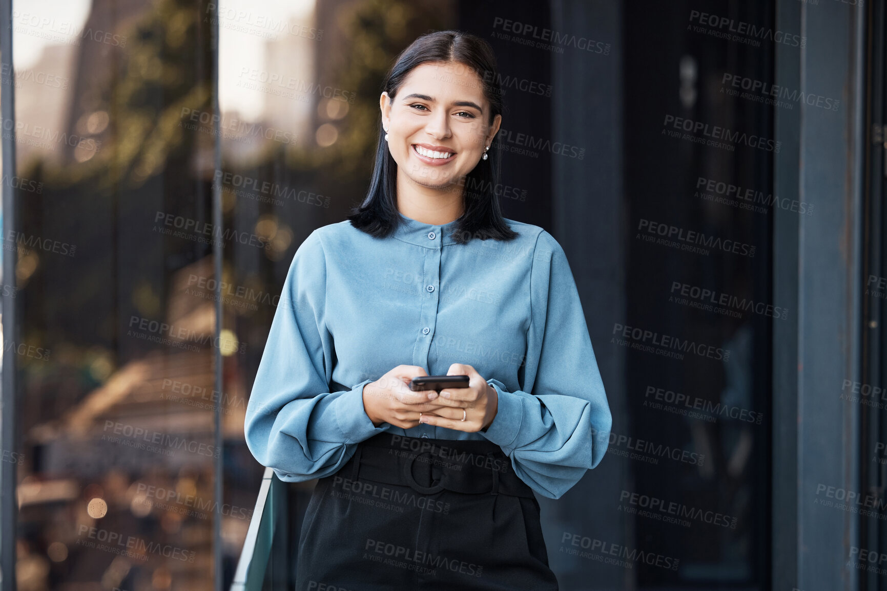 Buy stock photo Phone, portrait and happy with a business woman typing a text message while standing outdoor on an office balcony. Social media, smile and communication with a  female employee sending a mobile email