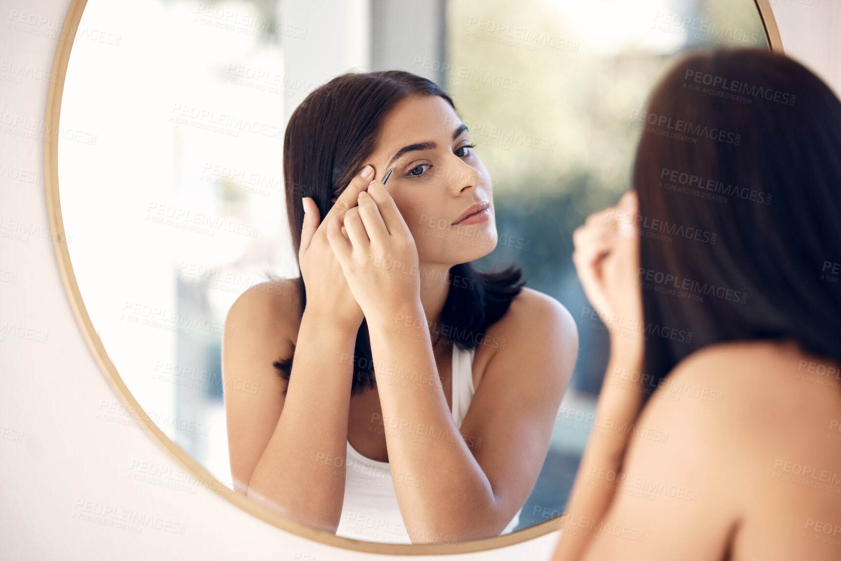 Buy stock photo Shape, eyebrow and woman in mirror of bathroom for beauty, microblading and makeup. Luxury, facial and wellness with face of girl at home and tweezers for cosmetics, cosmetology and skincare