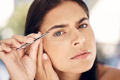 Buy stock photo Woman in mirror plucking eyebrows with tweezers and grooming facial routine in morning. Beauty, skincare and tweezing eyebrow hair, portrait of Indian woman face in reflection in bathroom treatment.