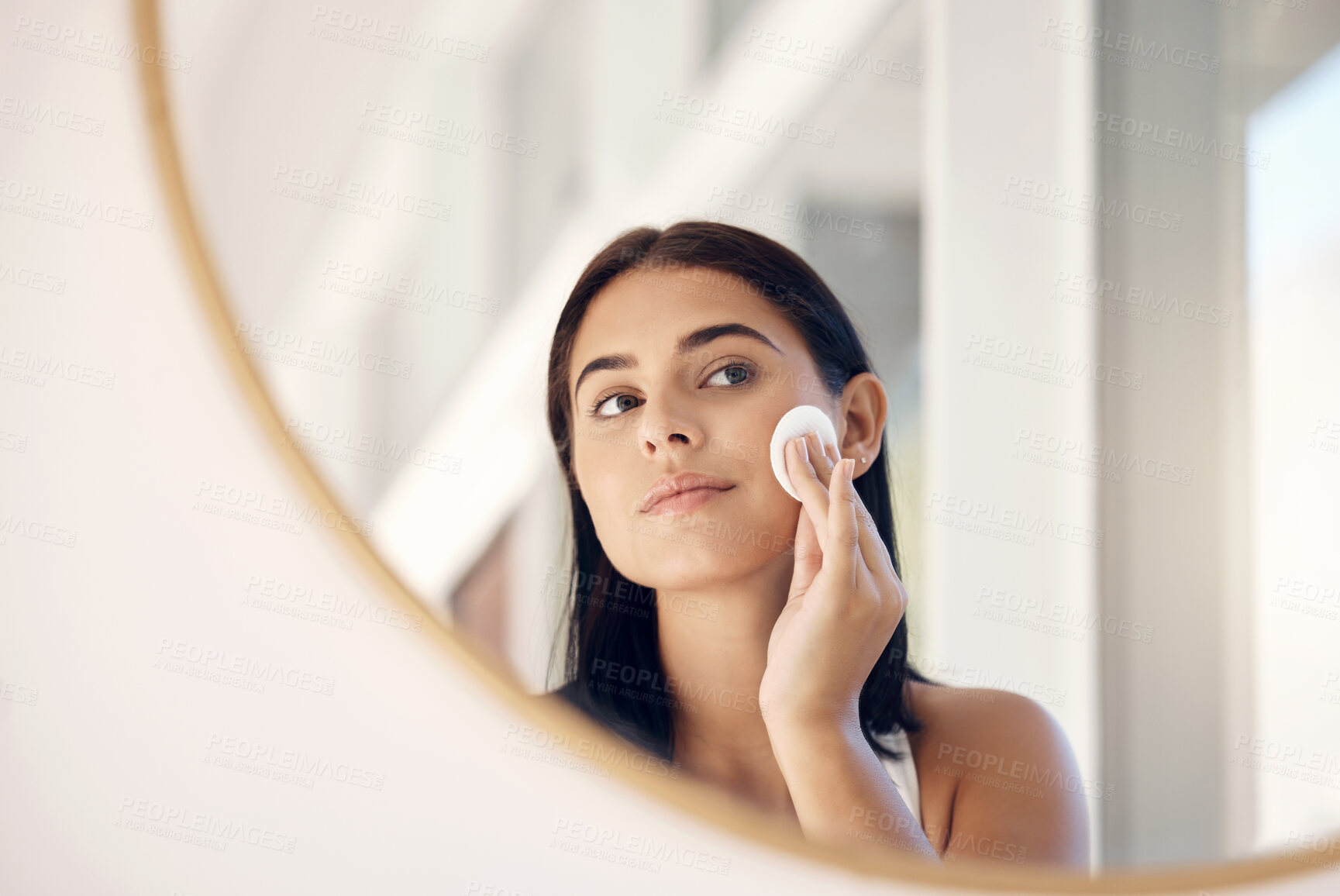 Buy stock photo Face, beauty and mirror with a woman cleaning her skin in the bathroom of her home in the morning. Skincare, reflection and cosmetics with an attractive young female going through her facial routine