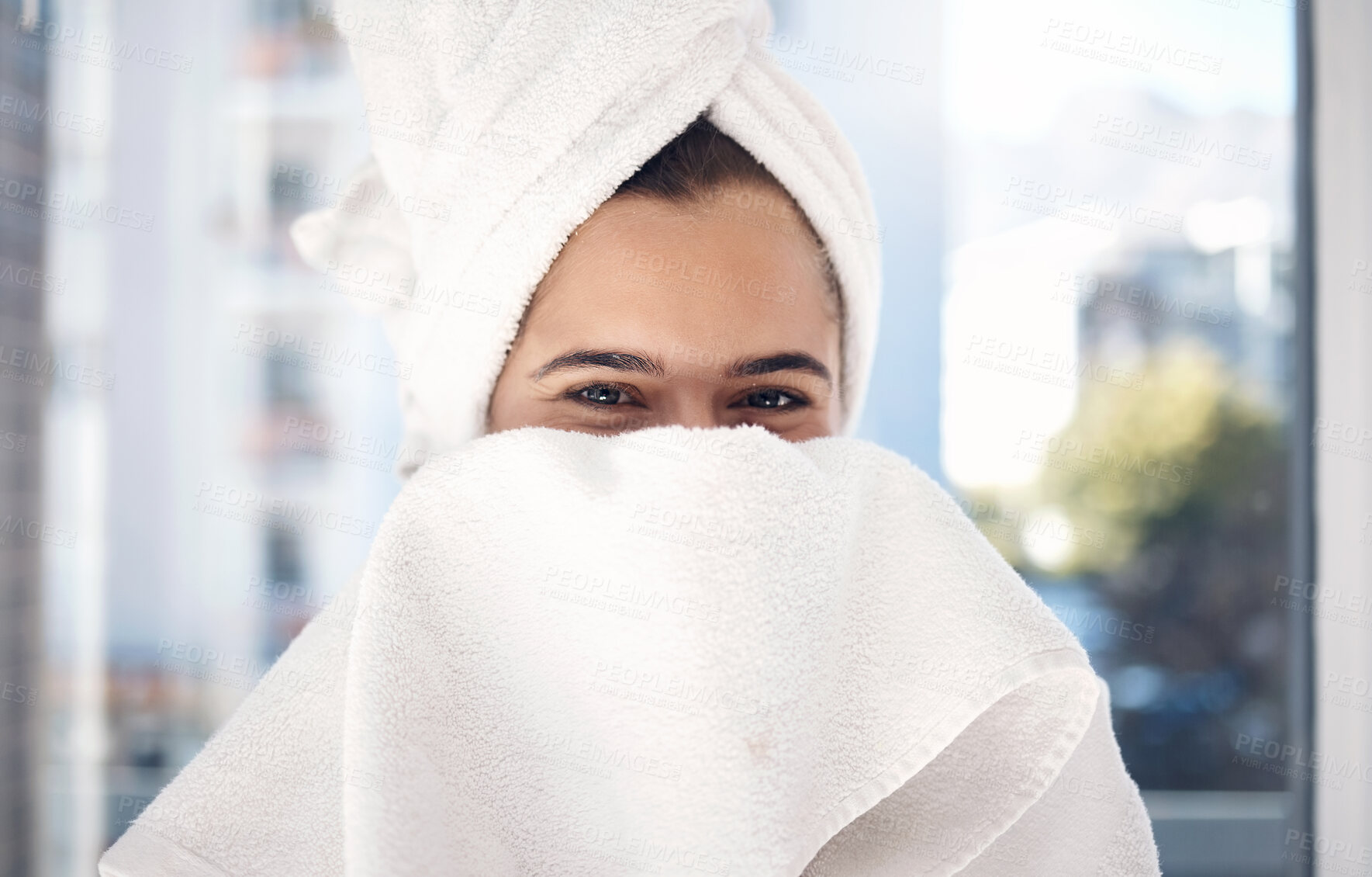 Buy stock photo Portrait, towel and woman after a shower, happy and relax while hiding face and grooming in her home. Shy, girl and beauty, skincare and routine in bathroom for cleaning, hygiene and fun in New York