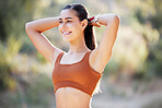 Sports, runner and woman stretching for fitness, running and exercise in park, happy and smile on bokeh background. Training, workout and arm stretch by girl in nature for cardio, wellness and run