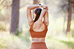 Fitness, stretch and woman in park for training, running and cardio health in nature, rear view and body preparation. Back, girl and arm stretch in a forest by runner start workout, run and exercise