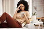 Stress, headache and phone by woman on a sofa with anxiety, bad news or break up text in her home. Confused, black woman and internet glitch on cellphone while texting, social media and browsing