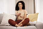 Woman, relax portrait and watching tv on sofa with remote control for television, relaxing and calm in living room at home. Black woman, happy and smile on couch, streaming movie, tv show or video