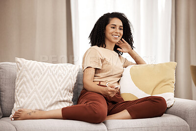 Buy stock photo Happy, woman and watching tv on a sofa, relax and laughing at comedy, movie and film in her home. Television, black woman and streaming show, entertainment and humour on a couch in a living room 