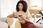 Black woman, smartphone and credit card on sofa for ecommerce, online banking and paying bills in living room. African American female, young lady or cellphone for connection, payment query and smile