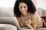 Laptop, credit card and woman on a sofa for online shopping, e commerce and payment in a living room, happy and smile. Ecommerce, black woman and online subscription upgrade, buying and shopping 