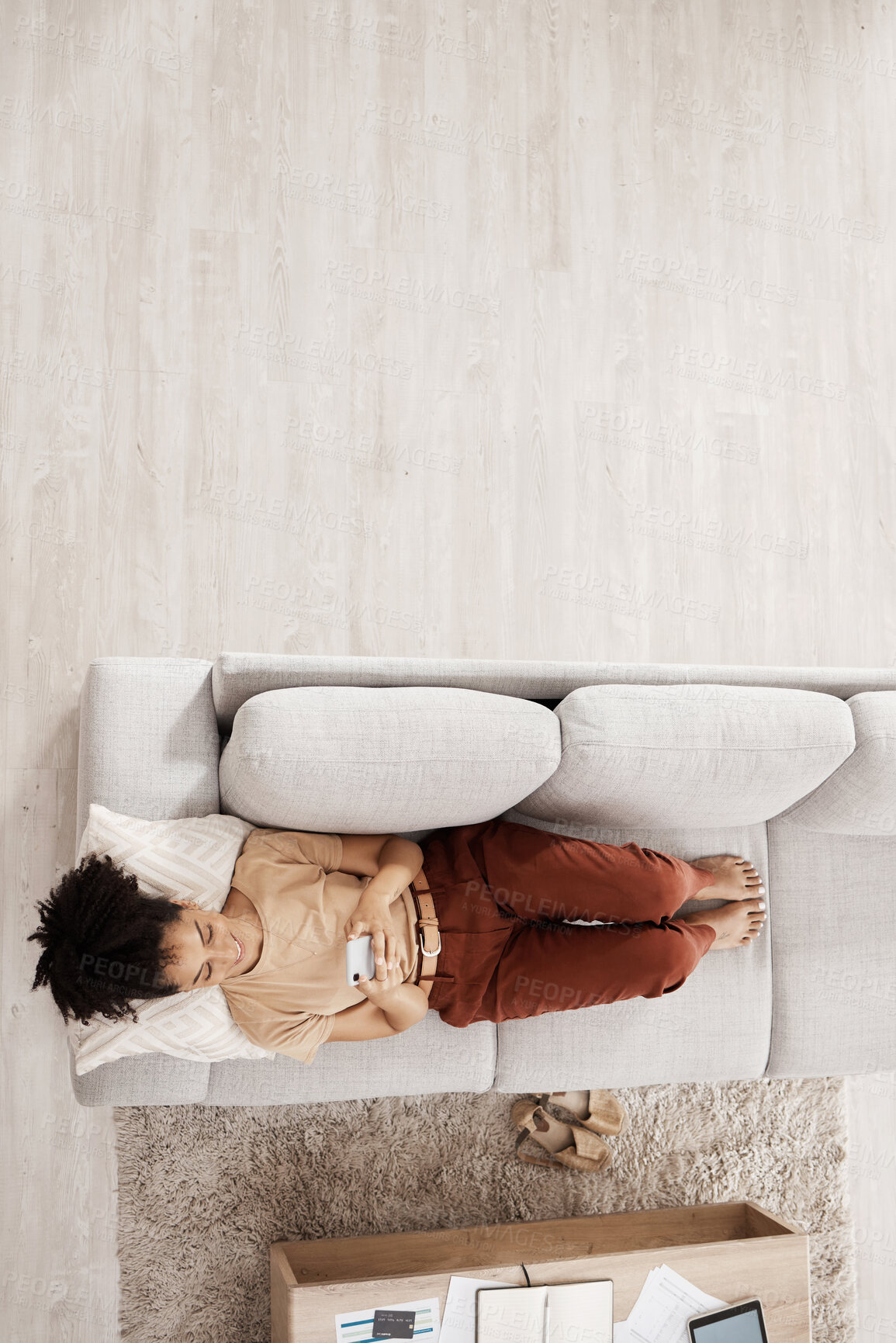 Buy stock photo Above view, black woman and sofa of a person on phone wifi looking at web and social media app. Living room lounge couch of a woman using mobile technology to relax at home in the morning on internet