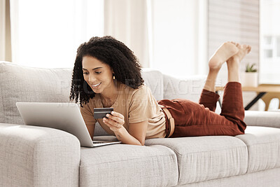 Buy stock photo Laptop, ecommerce and customer with a black woman online shopping using her credit card in the house. Computer, living room and payment with a female consumer using technology to shop on the sofa