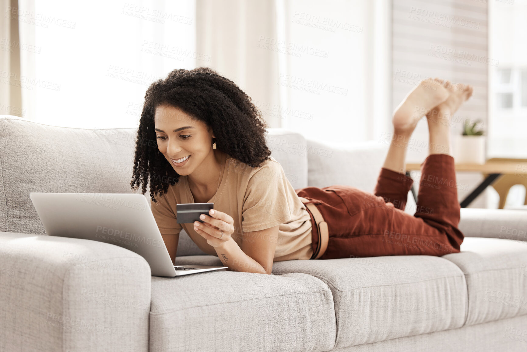 Buy stock photo Laptop, ecommerce and customer with a black woman online shopping using her credit card in the house. Computer, living room and payment with a female consumer using technology to shop on the sofa