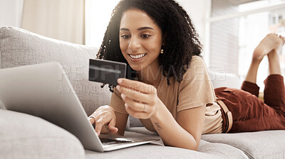 Buy stock photo Credit card, laptop and online shopping with a black woman customer lying on a sofa in a living room of her home. Computer, ecommerce and retail with a female consumer spending money on the internet