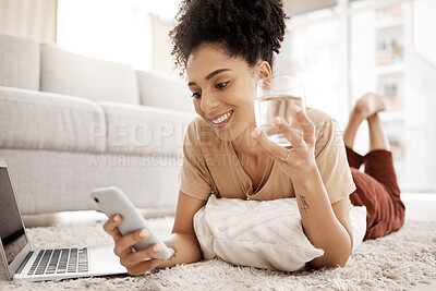 Buy stock photo Relax, phone and black woman on social media for news reading or funny online content on living room floor. Smile, meme or happy girl enjoys a glass of water for wellness or healthy hydration at home