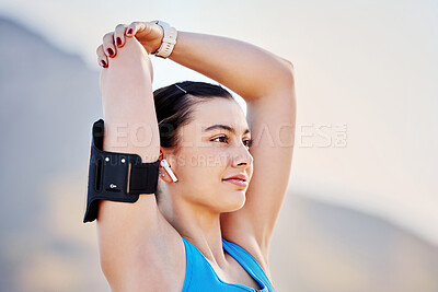 Buy stock photo Young woman, stretching and with arm band for exercise, training and fitness for health and relax outdoor. Healthy female, girl athlete and podcast for balance, calm or wellness for cardio or workout