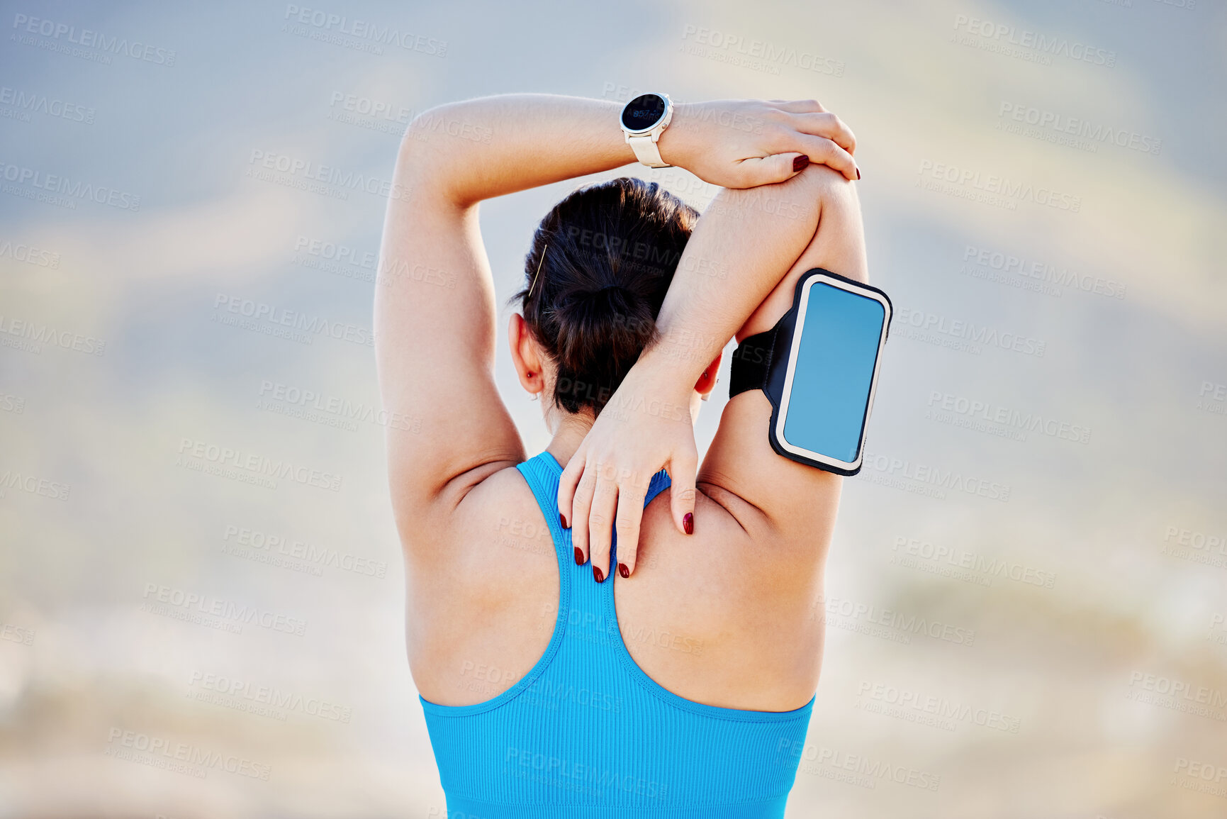 Buy stock photo Woman, stretching arms and back view in outdoor for fitness track on smartphone and healthcare exercise. Cardio training workout, sports motivation and athlete stretch body for runner performance 