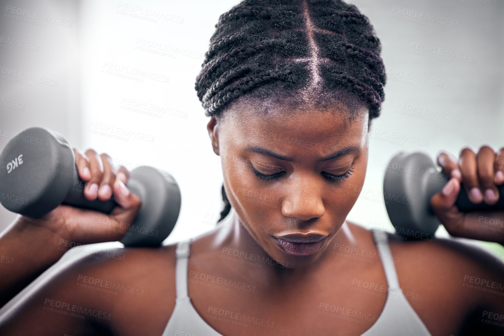 Buy stock photo Black woman, weightlifting dumbbells and gym with focus, strong body or muscle for health, wellness and fitness. African bodybuilder, woman and workout for exercise, weight training and power in club