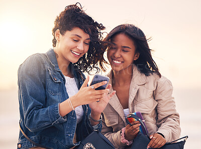 Buy stock photo Friends, phone and happy on social media outdoor for interracial creative content, streaming video online or web communication message app. Women, diversity and friendship or reading on smartphone