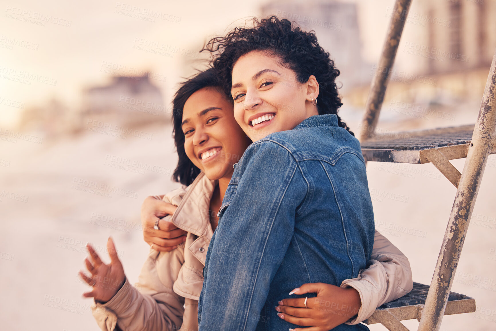 Buy stock photo Couple, lgbtq hug and smile on beach together for relax interracial portrait on travel vacation or quality time. Diversity, lesbian women and happy for love, support and care on summer holiday