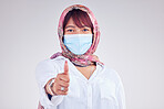 Covid face mask, muslim woman and thumbs up, portrait and vaccine yes vote, safety compliance and emoji, health risk and policy on studio background. Corona virus, thumb up and islamic female hijab