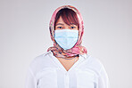 Covid, muslim and mask with a woman in studio on a gray background for health, safety or new normal. Face, portrait and Islam with a female wearing a hijab during the corona virus pandemic