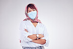 Covid, Muslim and portrait of woman with mask in white background studio for safety and virus protection. Healthcare, covid 19 and Islamic female with face mask, hijab and crossed arms in pandemic