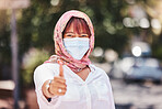 Success, hijab and woman thumbs up with covid protection on Turkey, Europe holiday walk in town. Yes, agreement and vacation of muslim travel person walking with face mask for corona safety.