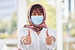 Business woman, covid and thumbs up for workplace compliance, corona virus health policy and muslim in face mask. Islamic employee portrait with ok, like and thank you sign for covid 19 safety goals