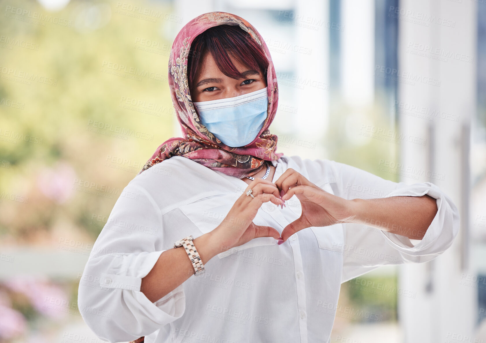 Buy stock photo Muslim, woman with hijab and covid, face mask with hand heart in city portrait, health and love outdoor. Compliance, hands and healthcare with safety and Islam, wellness and covid 19 care and safe.