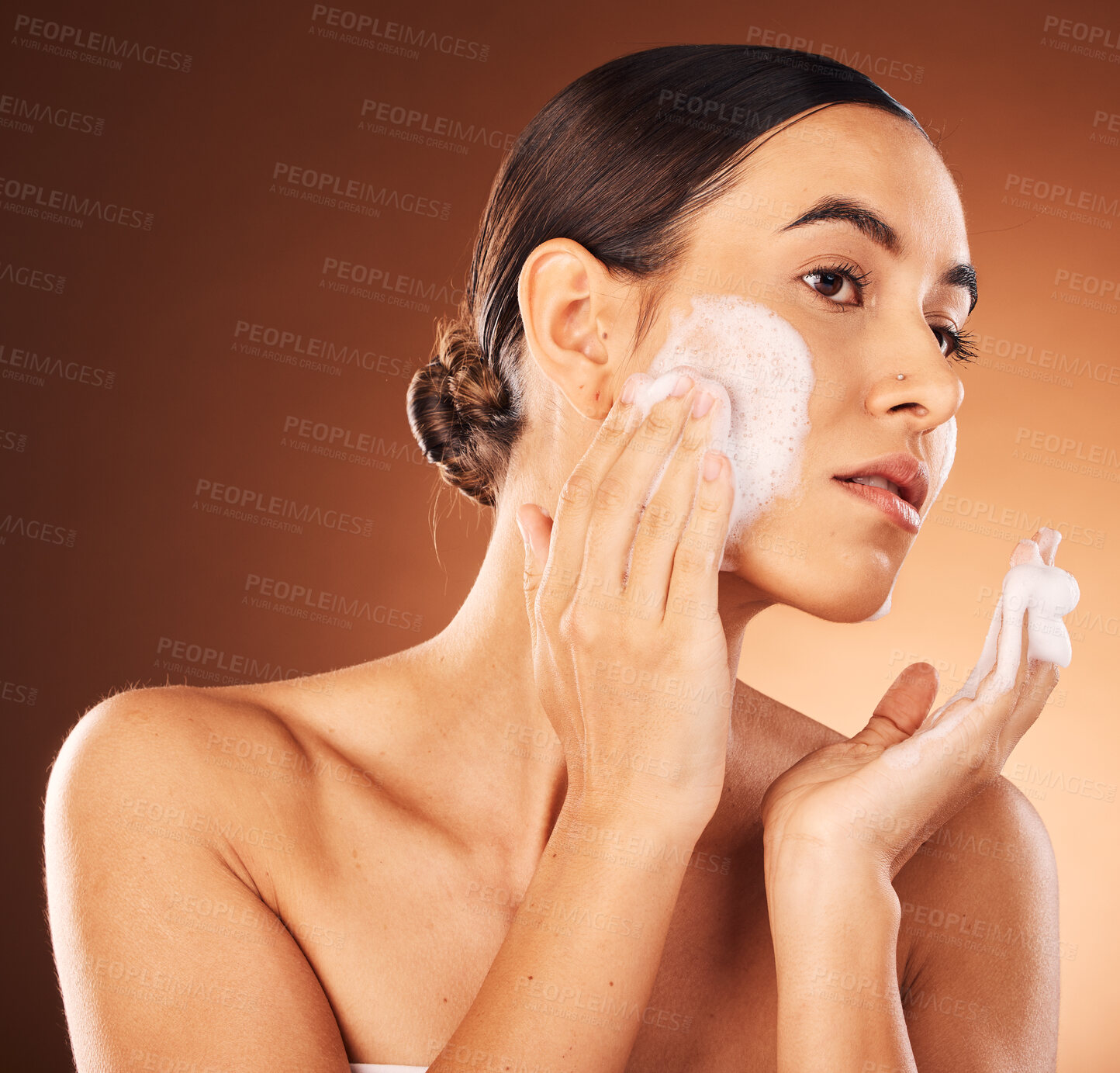 Buy stock photo Woman, face wash and soap on studio background, healthy skincare and natural cosmetics, body wellness and luxury makeup. Young model, facial cleaning and foam, self care and aesthetic of beauty shine