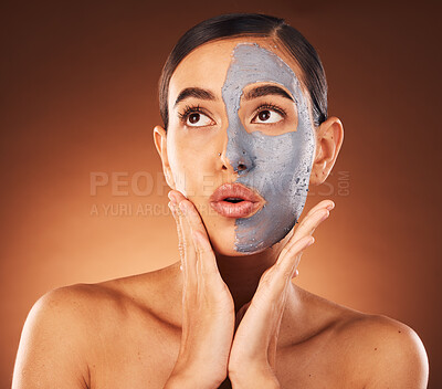 Buy stock photo Woman, clay face mask and beauty, facial and expression, dermatology and studio background. Thinking model, charcoal cosmetics and glowing skincare, shine and aesthetic transformation for acne